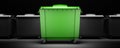 Green garbage container among gray containers isolated