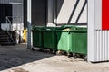 Green garbage containers on backyard of store. Royalty Free Stock Photo