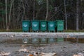 Green garbage containers in the forest in a row Royalty Free Stock Photo