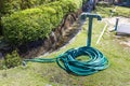 Green garden hose on the ground Royalty Free Stock Photo