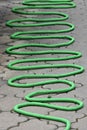 A green garden hose on the ground Royalty Free Stock Photo