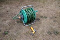 Garden hose reel on dry grass Royalty Free Stock Photo