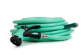 Green garden hose with spray nozzle Royalty Free Stock Photo