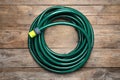 Green garden hose on table, top view Royalty Free Stock Photo