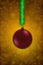 A green garland with a red Christmas ball.