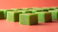 Green gelatin cubes on a red background Royalty Free Stock Photo