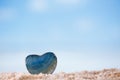 Green gem stone heart on white sand beach Royalty Free Stock Photo