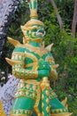 Green giant statue standing at the entrance of Ang Hin Temple, Cha-am in Thailand.