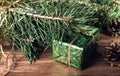 Green gift box under Christmas tree branches Royalty Free Stock Photo