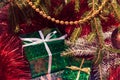 Green gift box under Christmas tree branches Royalty Free Stock Photo