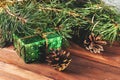 Green gift box under Christmas tree branches Royalty Free Stock Photo