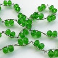 Green glass beads on white background.