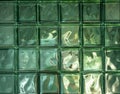 Green glass blocks background, texture of square bathroom wall tiles with reflection and light effect. Royalty Free Stock Photo