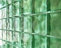Green glass blocks background, texture of square bathroom wall tiles with reflection and light effect. Royalty Free Stock Photo