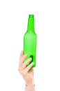 green glass bottle in female hand on a white Royalty Free Stock Photo