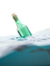 Green glass bottle with letter in the sea Royalty Free Stock Photo