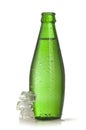 Green glass bottle of mineral water with ice Royalty Free Stock Photo