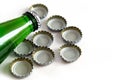 Green glass bottle of mineral water and metal soda bottle with caps, soda caps, close-up on white background Royalty Free Stock Photo