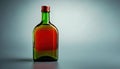 Green glass bottle with red liquid on a smooth surface in studio lighting Royalty Free Stock Photo