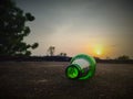 Green glass bottles of beer at sunset sky. Empty beer bottle. Royalty Free Stock Photo