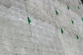 Green glass bottles hanging on a high wall with a chain designed to protect the wall