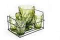 green glass carafe and glasses for drinks in a metal basket. set of tableware