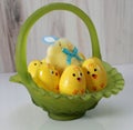 green glass Easter basket, chickie eggs, soft yellow chick with bow Royalty Free Stock Photo
