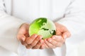 Green glass globe in hand Royalty Free Stock Photo