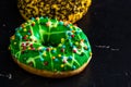 Green glazed donut with sprinkles isolated. Close up of colorful donut Royalty Free Stock Photo