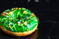 Green glazed donut with sprinkles isolated. Close up of colorful donut Royalty Free Stock Photo