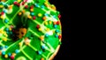 Green glazed donut with sprinkles isolated. Close up of colorful donut Royalty Free Stock Photo