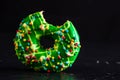 Green glazed donut with sprinkles isolated. Close up of colorful bitten donut Royalty Free Stock Photo