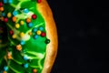 Green glazed donut with sprinkles isolated. Close up of colorful donut Royalty Free Stock Photo