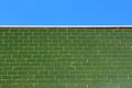 Green glazed tile wall and the blue sky