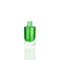 Green glittering nail polish in glass bottle on white background isolated closeup, opened green sequin varnish, shiny lacquer