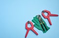 Green glove and metal universal adjustable wrench on a blue background, top view