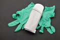 Green glove and white portable roll on depilatory wax heater beauty device on black background. Hair removal. Preparing for