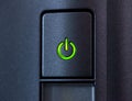 Green glowing power button. Closeup Royalty Free Stock Photo