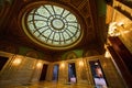 Green and gold walls in fancy entrance with Celtic stained glass on dome ceiling