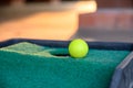 Green golf ball on edge hole cup on lawn putt Royalty Free Stock Photo