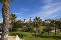 Green golf course and palm roars and blue sky with beautiful clouds in Benidorm, Spain Royalty Free Stock Photo