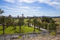 Green golf course and skyscrapers on the horizon and blue sky with beautiful clouds in Benidorm, Spain Royalty Free Stock Photo