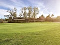 Green golf field and blue cloudy sky. american landscape Royalty Free Stock Photo