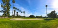 Green golf field and blue cloudy sky. american landscape Royalty Free Stock Photo