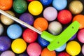 Green Golf Putter with Colorful Balls Royalty Free Stock Photo