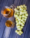 Green grape bunch and a pitcher of juice top view