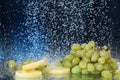 Green grape closeup under the water drops in a dark blue background. Healthy lifestyle. Multivitamin cocktail. Summer diet. Set of