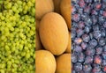 Green grapes, ripe yellow melon, blue plum. Royalty Free Stock Photo