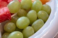Green grapes served in a plastic fruit tray