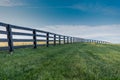 Green Grass with Black Fence Over Hill